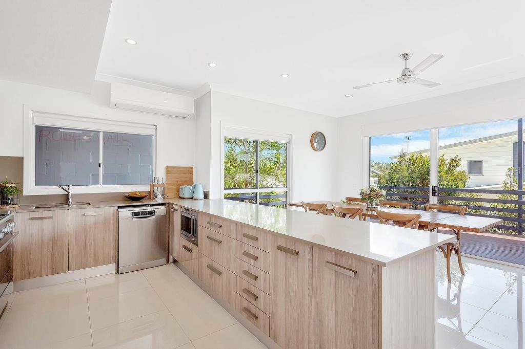 A bright, freshly cleaned kitchen and dining space